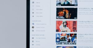 Person browsing YouTube videos on a laptop, showcasing modern technology and online content.